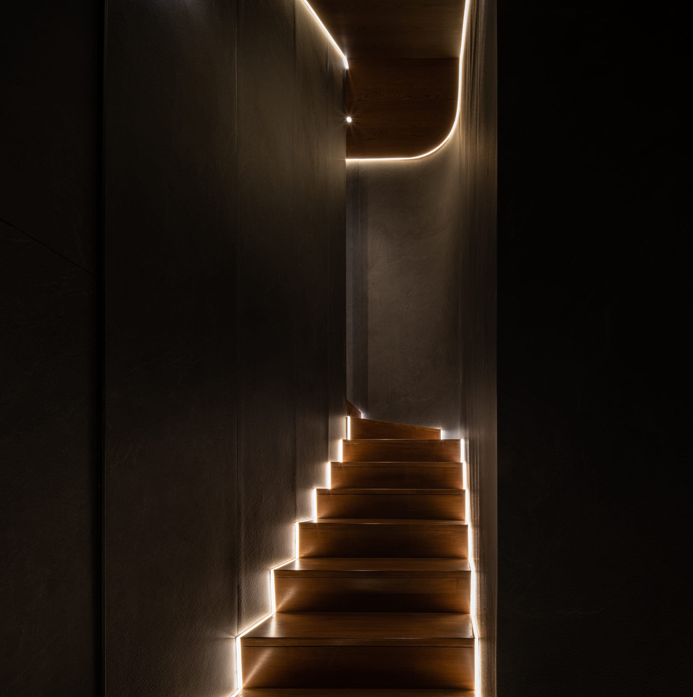 Basement stair and warm light at ARQ10 L-House
