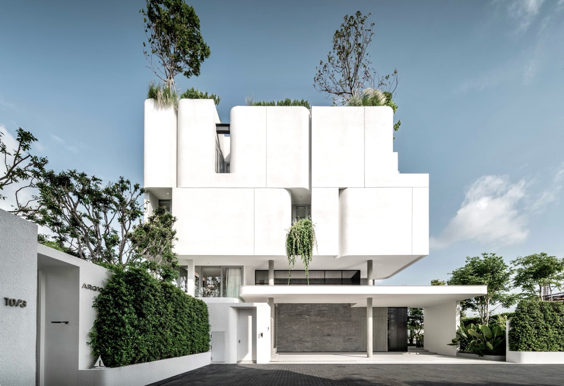 Completed ARQ10 L-House exterior with mature landscape